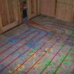 Tubing and manifold on a wood sub floor